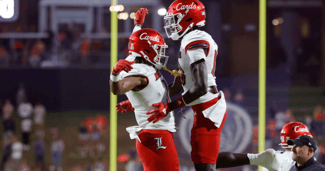 Louisville Duke Watson (26) catches the ball and ran from some yardage against Red Louisville Rodney Johnson (7) in the Spring Game Friday night at L & N Stadium. April 11, 2025